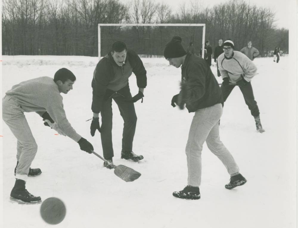 Students playing sports in the snow.